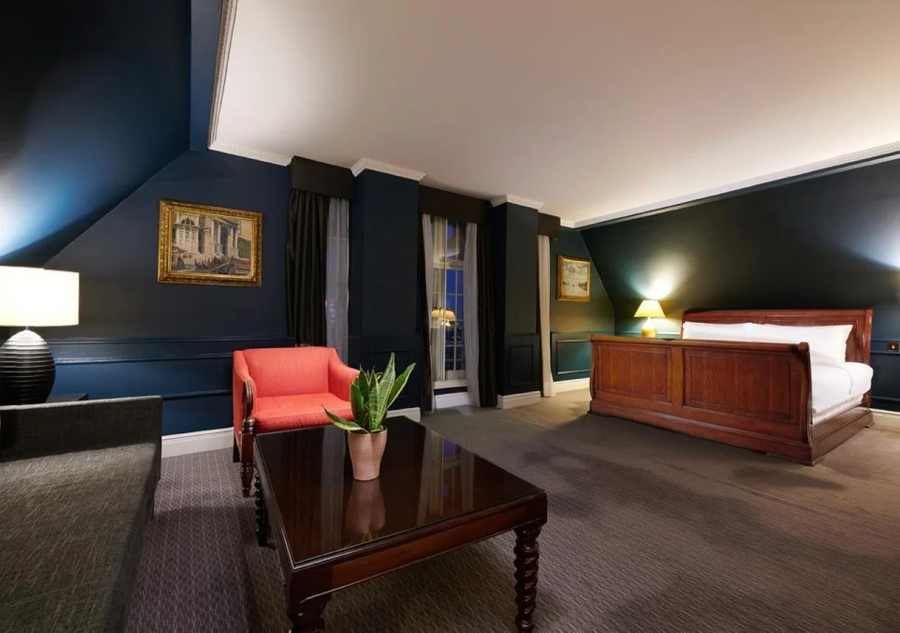 Spacious hotel room with elegant wooden bed.