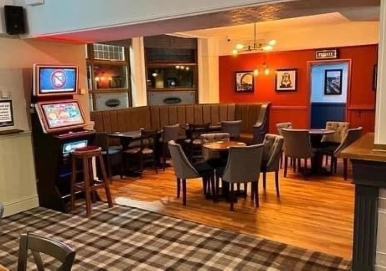 Cozy pub interior with tables and chairs.