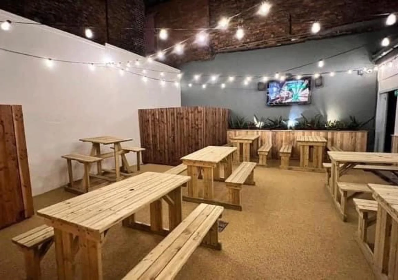 Rustic indoor seating area with string lights.