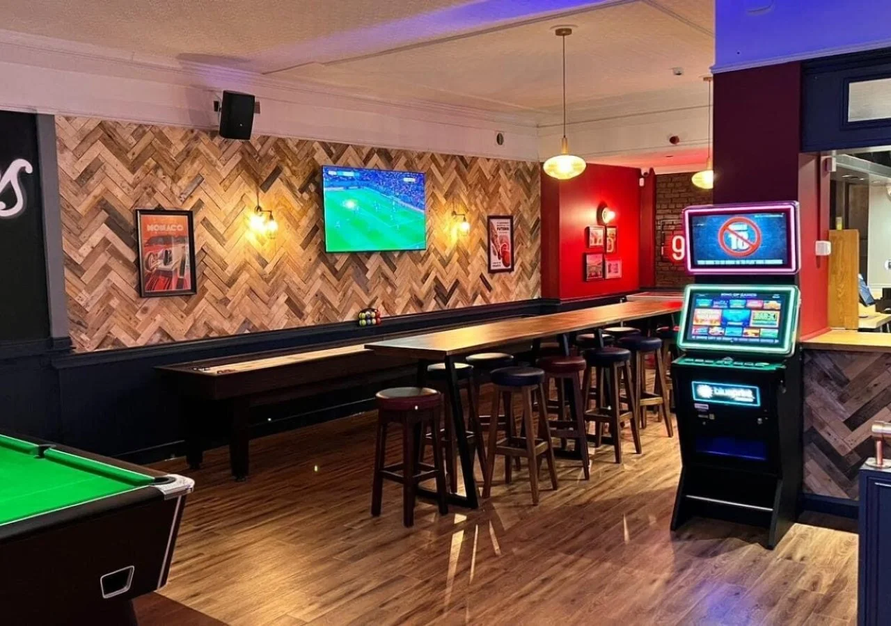 Pub interior with pool table and TV.