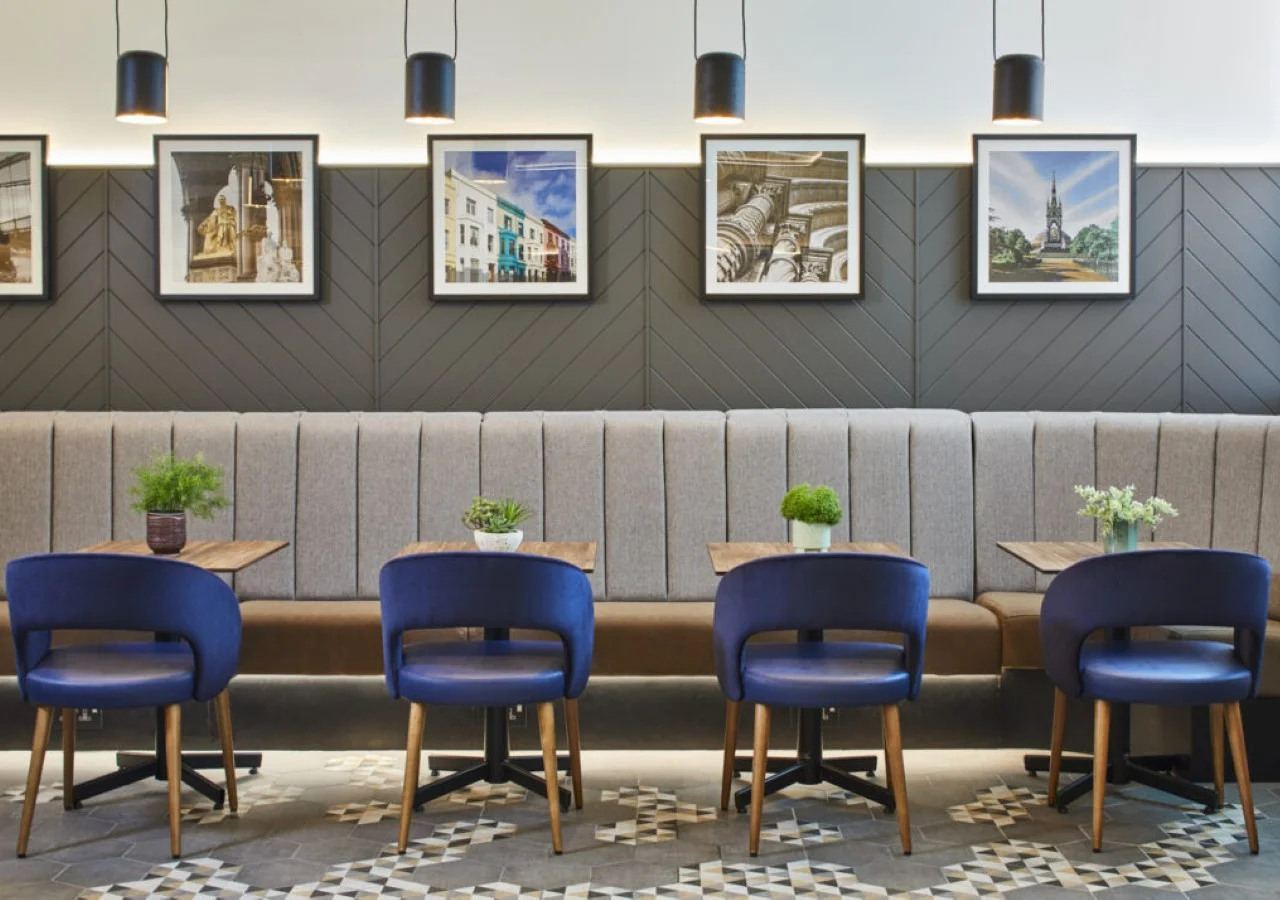 Modern cafe seating with blue chairs.