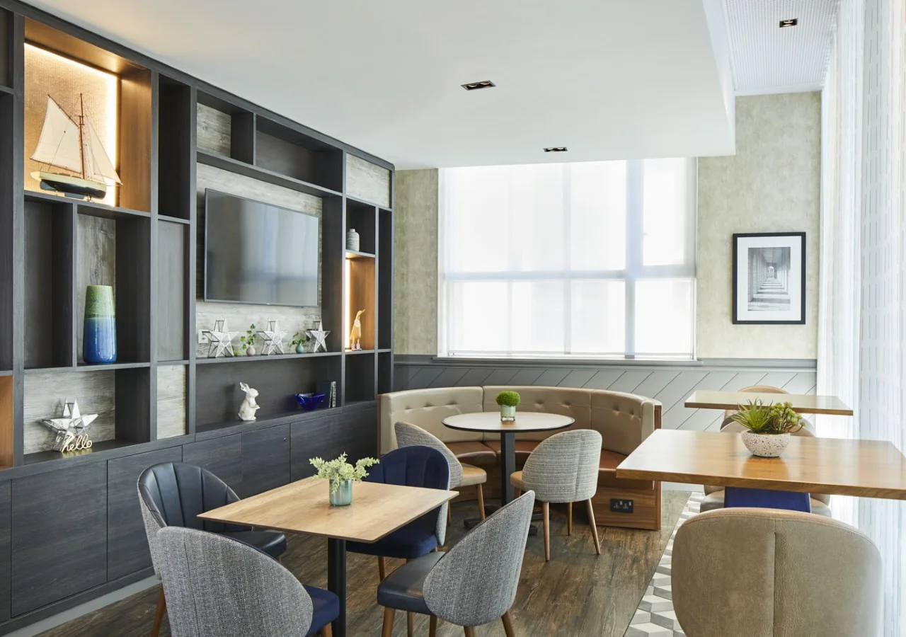 Modern cafe with tables and wall decor.