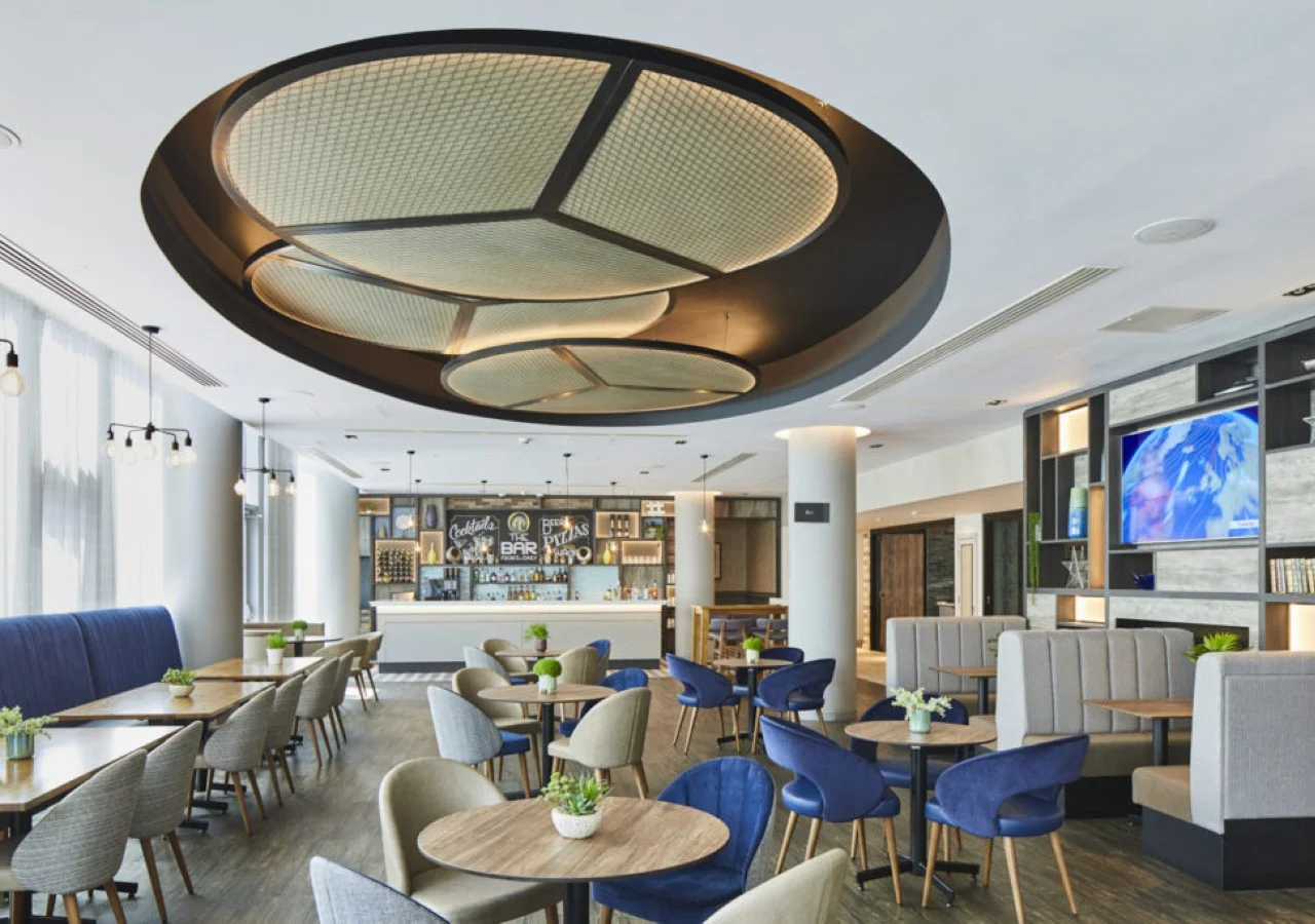 Modern restaurant interior with circular ceiling design.